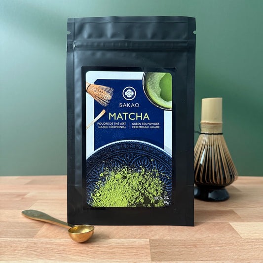 Sakao Matcha green tea powder package on a wooden surface with a blurred background